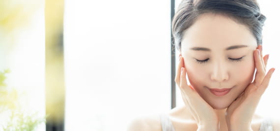 自分の顔を触る女性